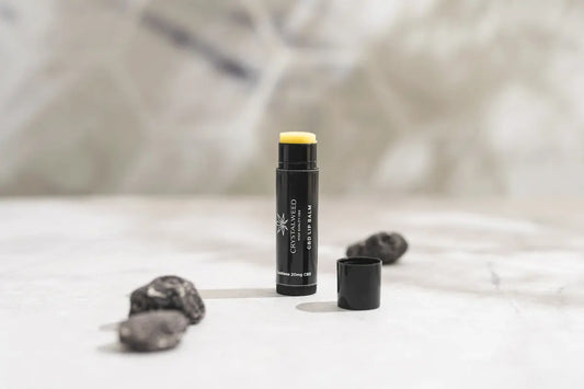 a close up of a tube of lipstick on a bed