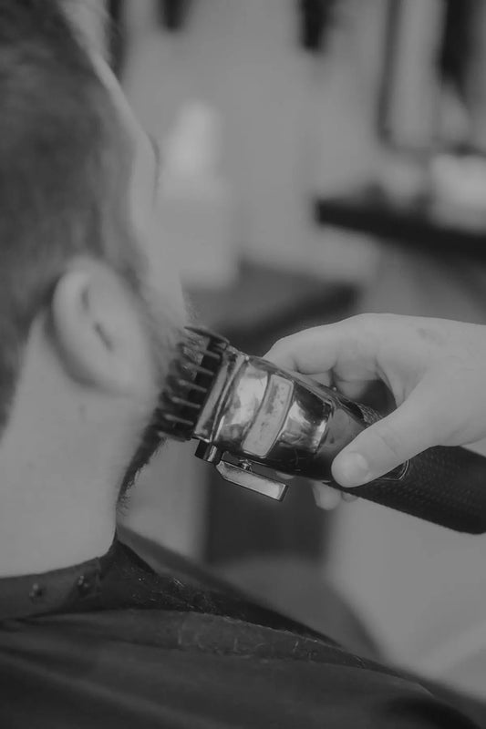 Someone is getting their beard trimmed with clippers
