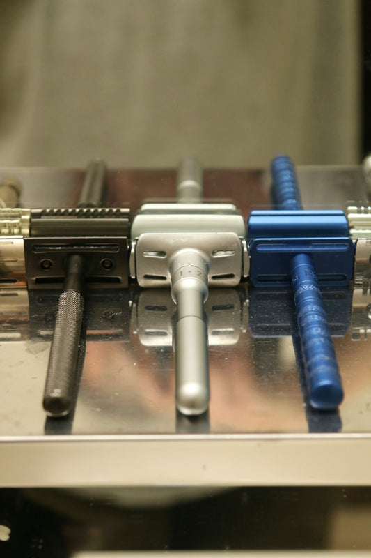 Three safety razors lined up in a row.