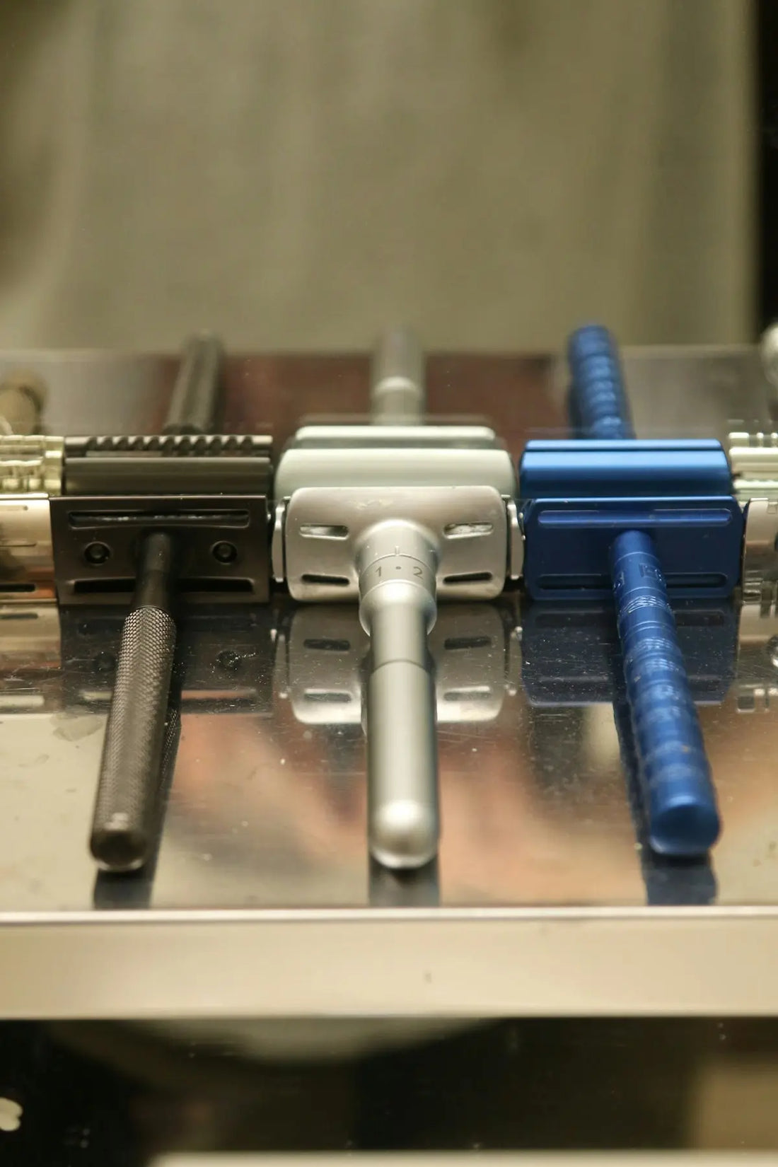 Three safety razors lined up in a row.