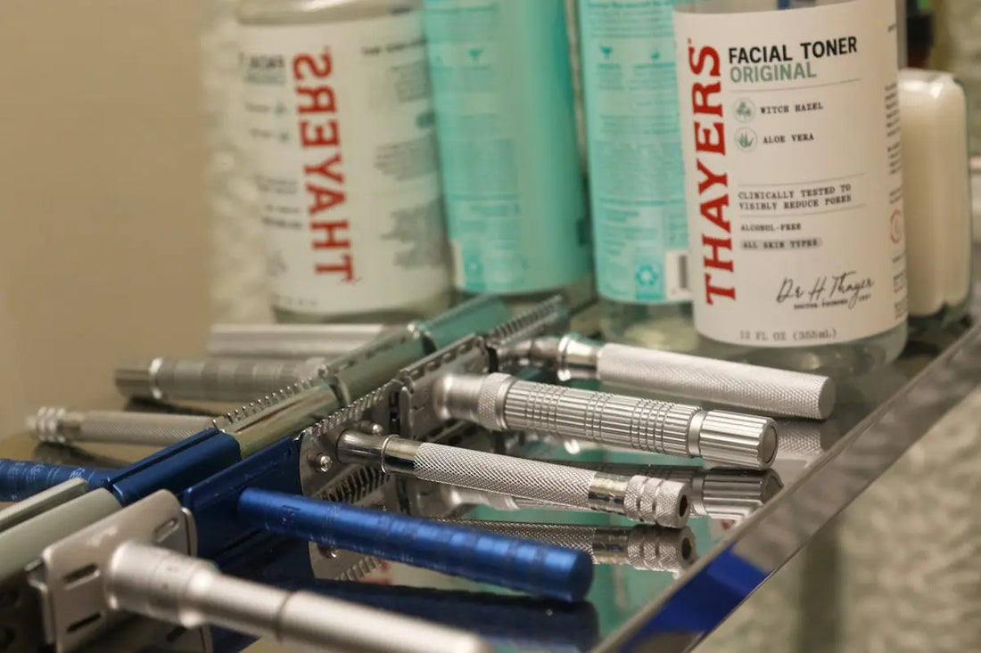 Collection of vintage safety razors and facial toner bottles.