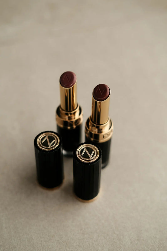 Two dark red lipsticks with gold accents