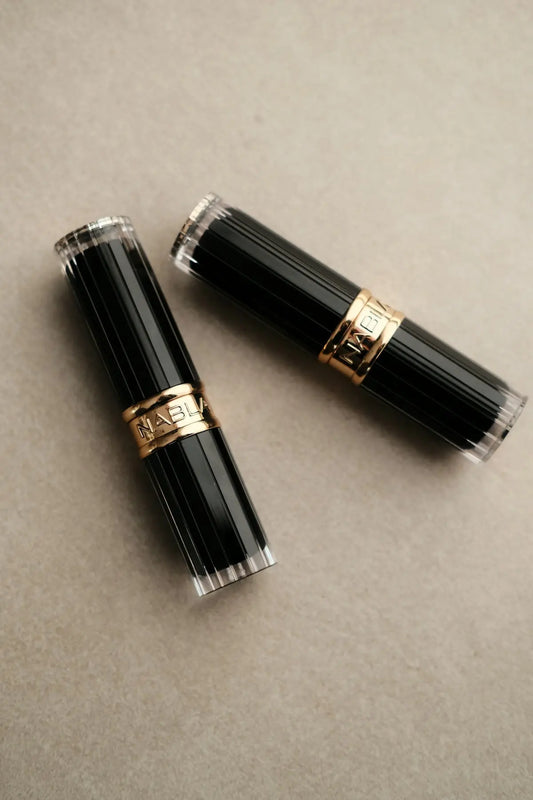 Two black lipstick tubes with gold bands