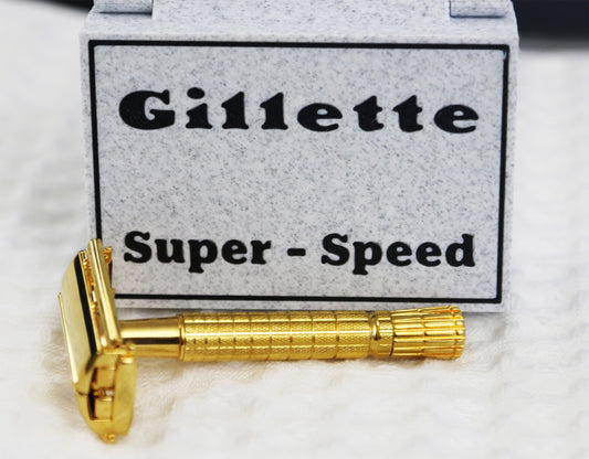 A gold gillette super-speed razor with its box.