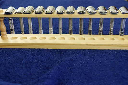 Metal safety razors organized in a wooden display stand.